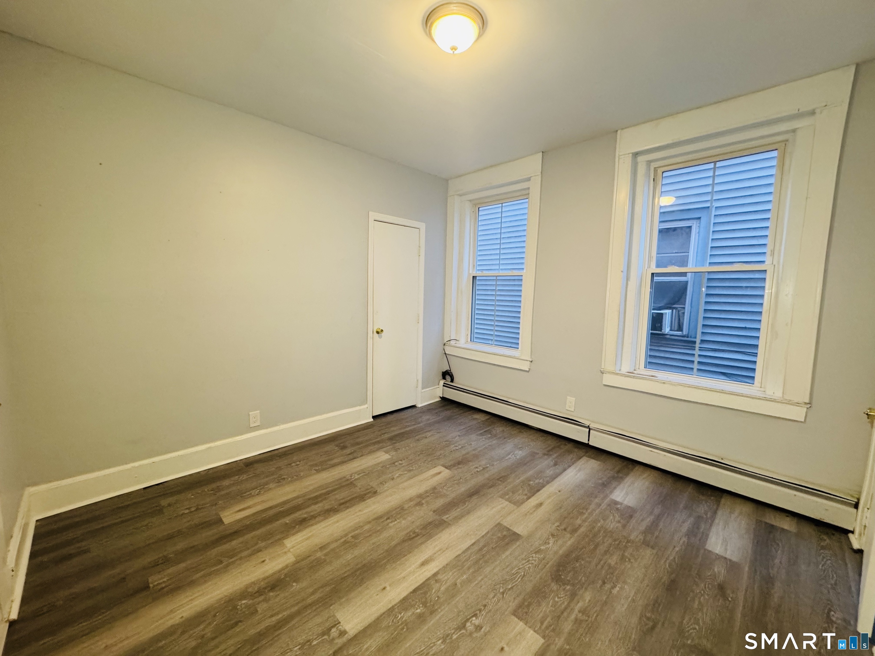 29 White Street, Unit 1 New Haven, CT 06519 - Photo 6 of 11 a view of an empty room with wooden floor and a window