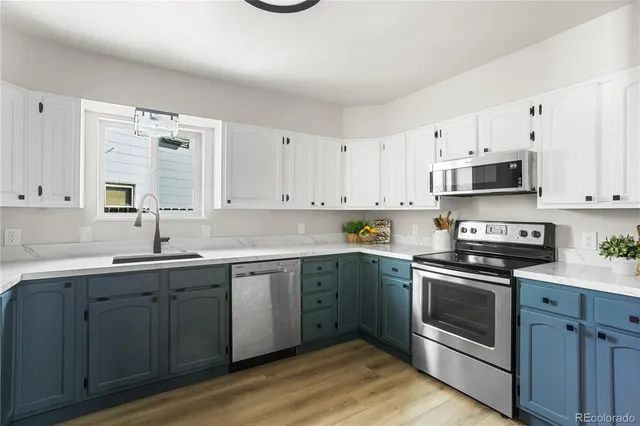a kitchen with sink cabinets and stainless steel appliances