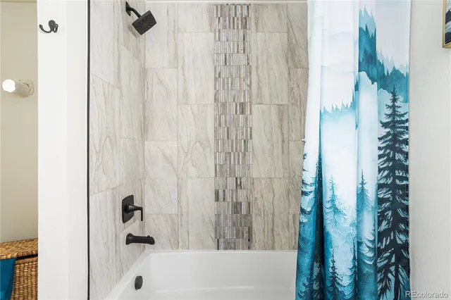 a bathroom with a bathtub and shower