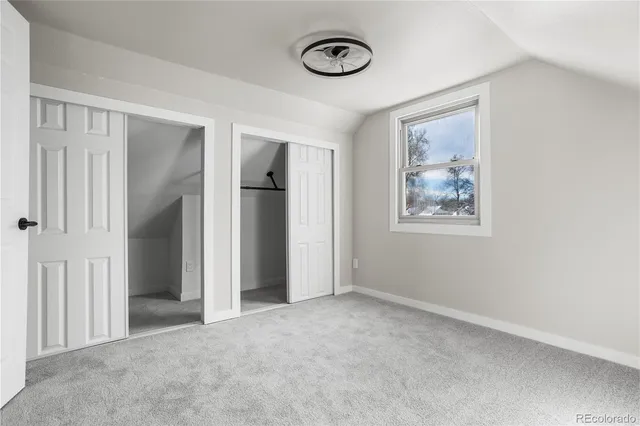 an empty room with a door and a window