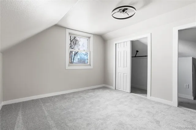 an empty room with cabinet and a window