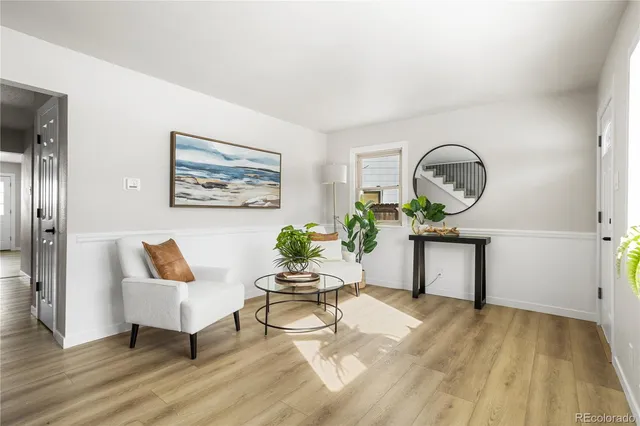 a living room with furniture a bathtub and a potted plant