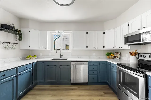 a kitchen with cabinets and stainless steel appliances