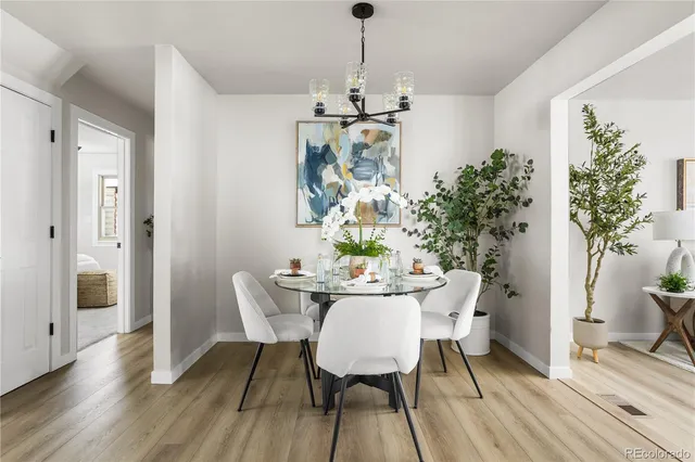 a view of a dining room with furniture wooden floor and chandelier