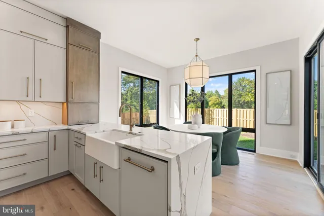 a dining room with furniture a chandelier and wooden floor