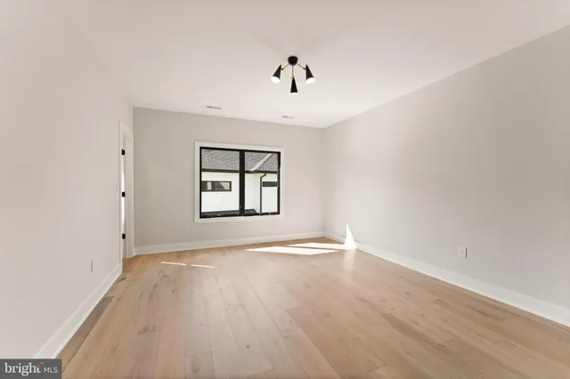 a living room with furniture and a painting on the wall