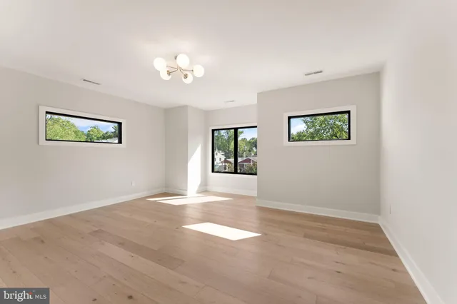 a living room with furniture and a lamp