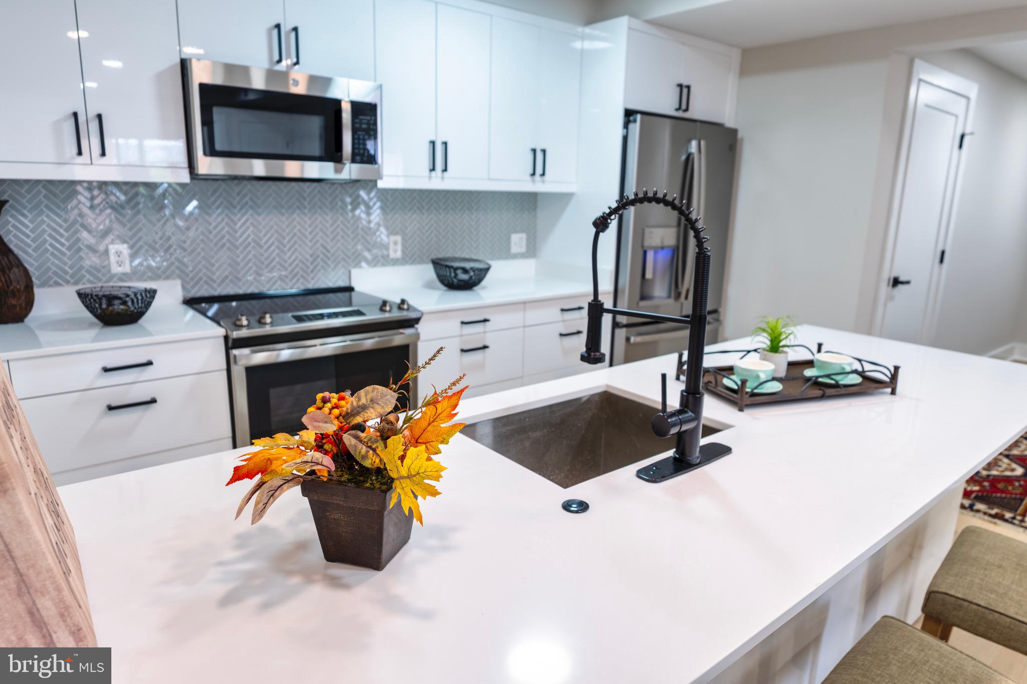 919 12th Street Northeast, Unit 202 Washington, DC 20002 - Photo 1 of 32 a kitchen with a stove a sink and a refrigerator