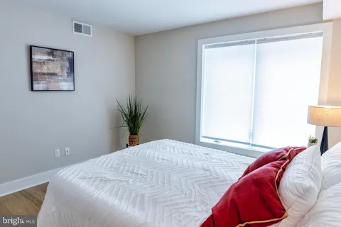 a bedroom with a bed and a shower