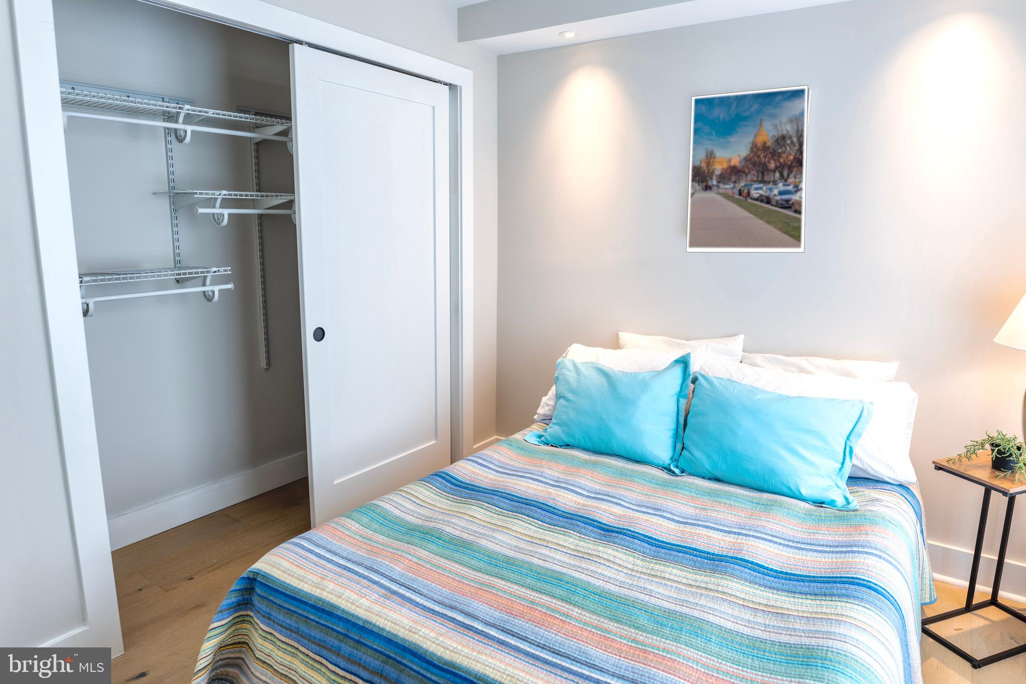 919 12th Street Northeast, Unit 202 Washington, DC 20002 - Photo 20 of 32 a bedroom with a bed and a rug