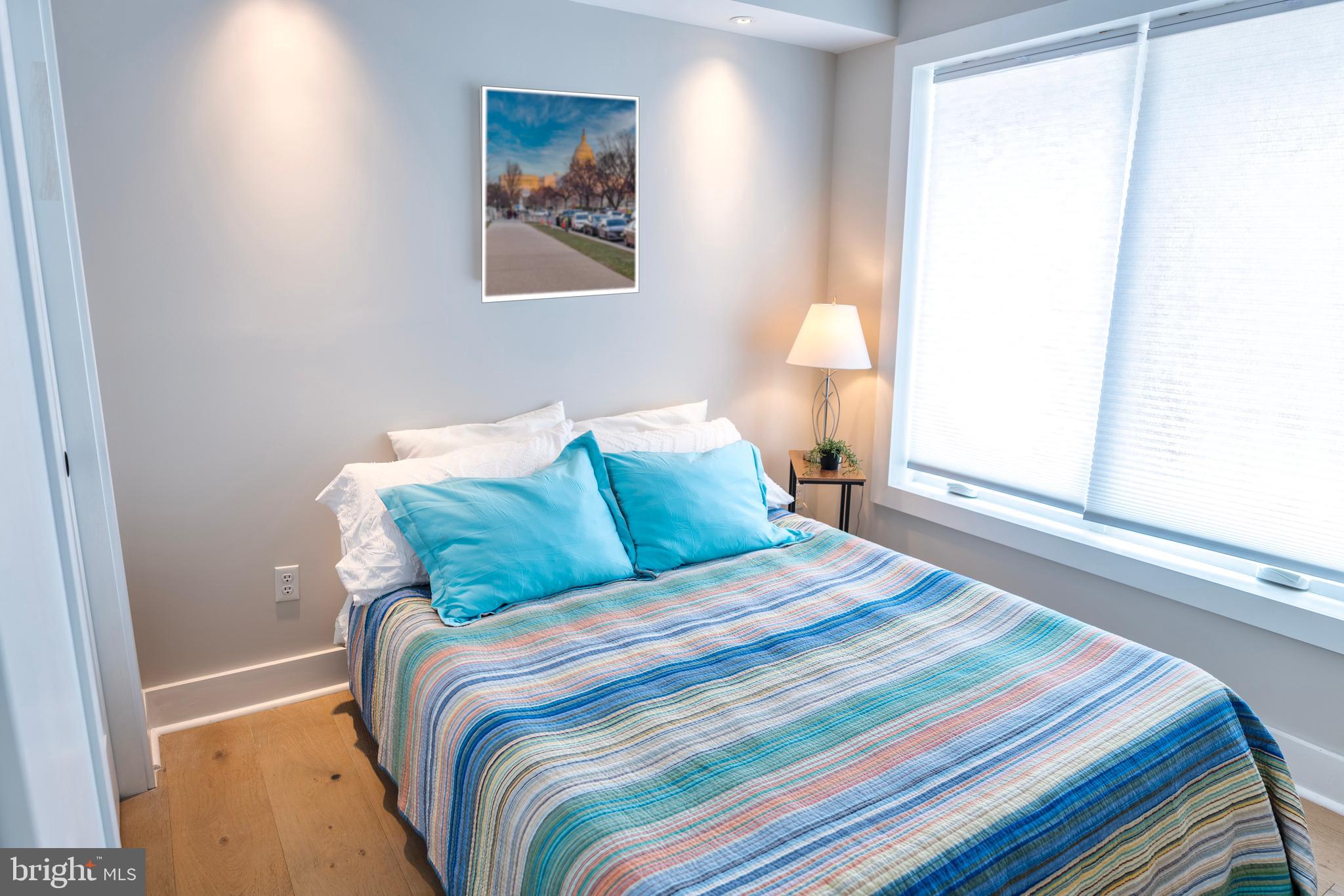 919 12th Street Northeast, Unit 202 Washington, DC 20002 - Photo 21 of 32 a bedroom with a bed and a window