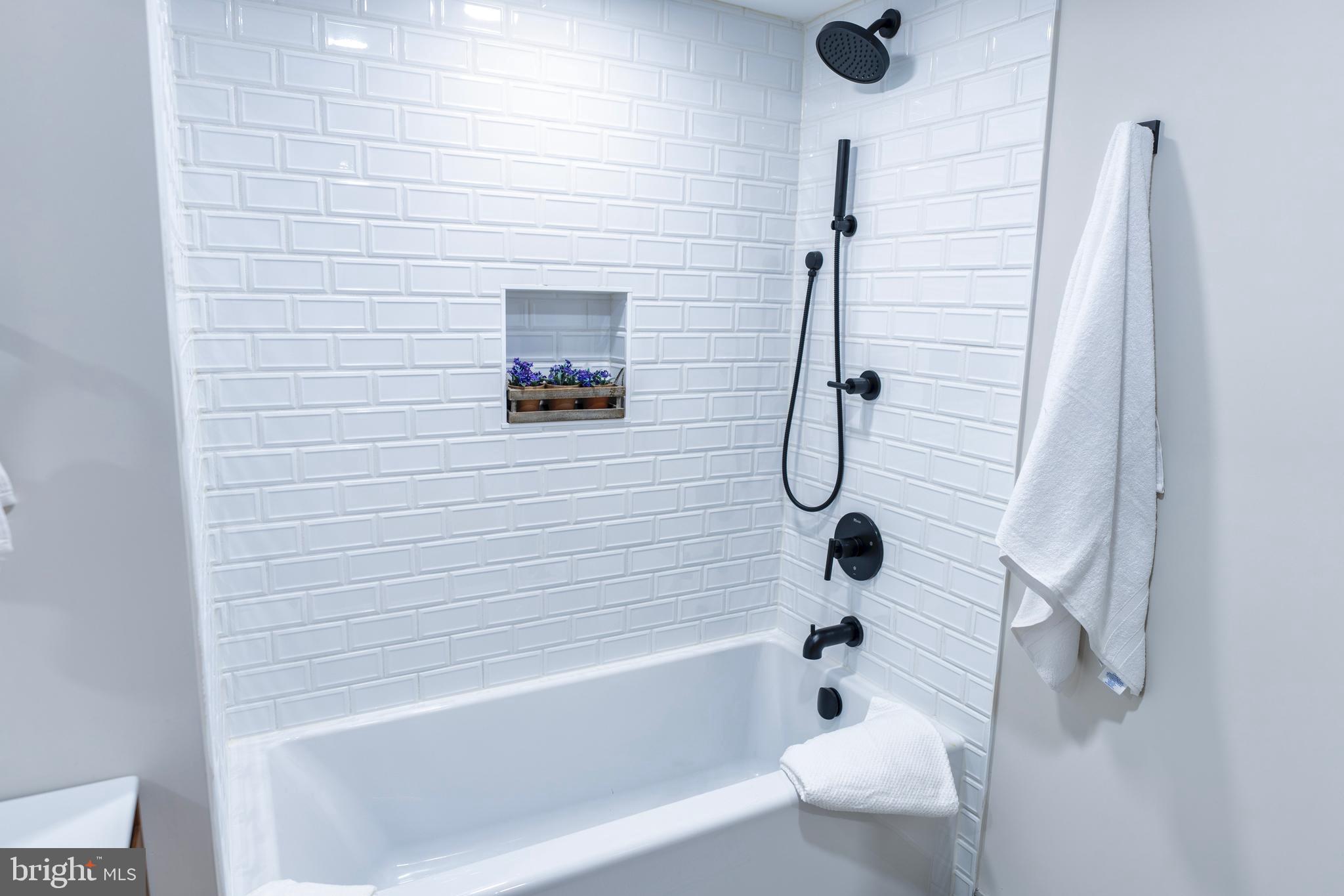 919 12th Street Northeast, Unit 202 Washington, DC 20002 - Photo 23 of 32 a bathroom with a shower and a tub