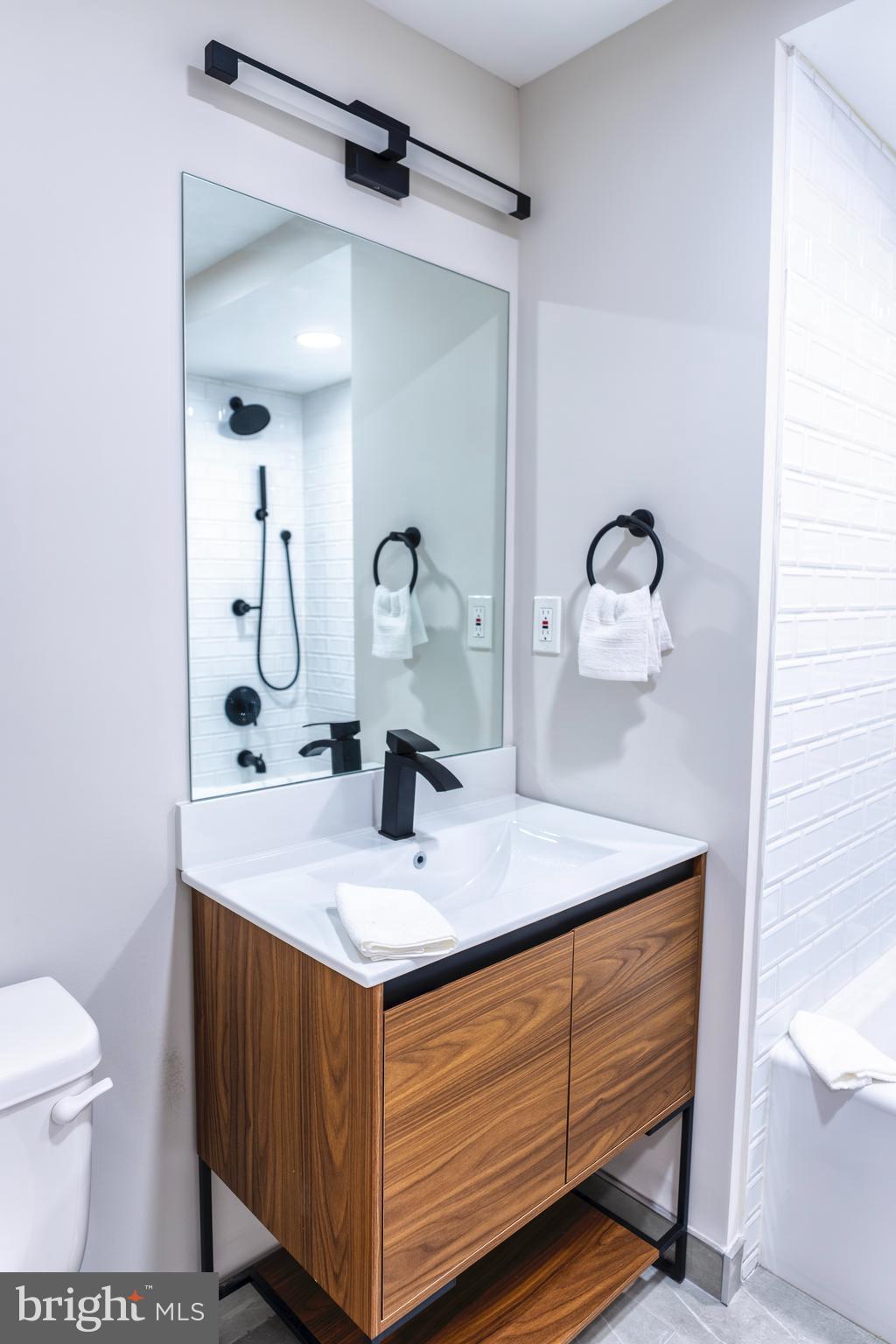 919 12th Street Northeast, Unit 202 Washington, DC 20002 - Photo 24 of 32 a bathroom with a sink double vanity and a mirror
