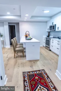 a open kitchen with stainless steel appliances granite countertop a sink and a stove