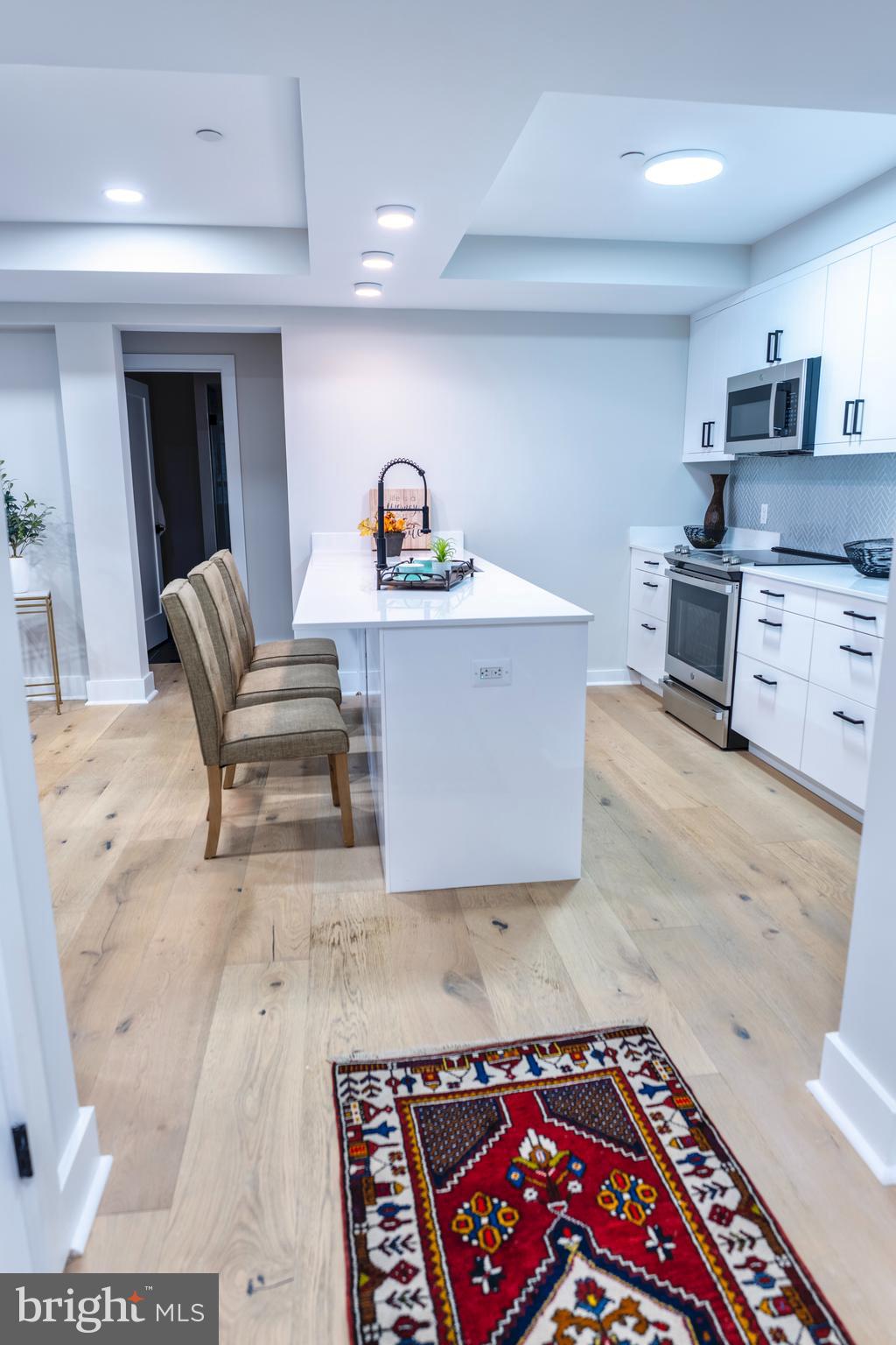 919 12th Street Northeast, Unit 202 Washington, DC 20002 - Photo 4 of 32 a open kitchen with stainless steel appliances granite countertop a sink and a stove