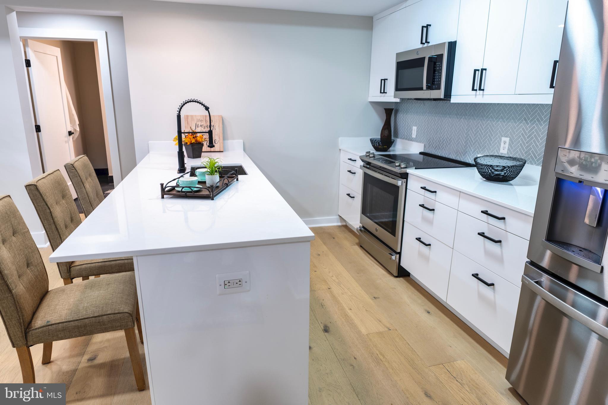 919 12th Street Northeast, Unit 202 Washington, DC 20002 - Photo 5 of 32 a kitchen with sink microwave and stove