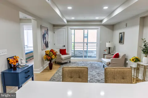 a living room with furniture chess board and a window