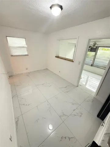 an empty room with windows and pillars in it