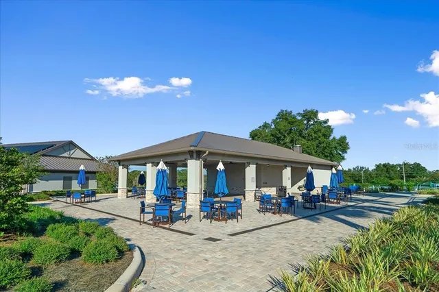 a view of a house with swimming pool and sitting area