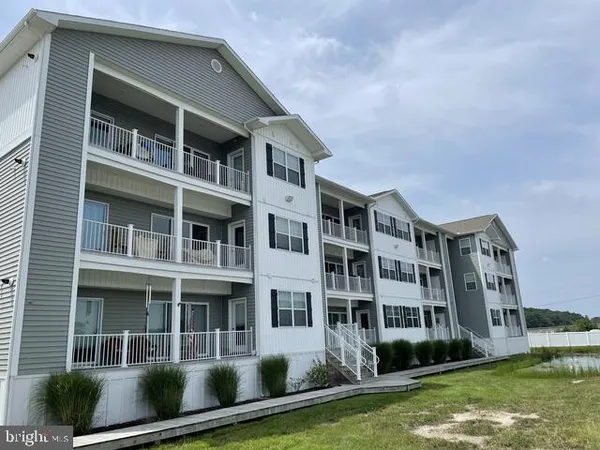 a front view of a building with a yard