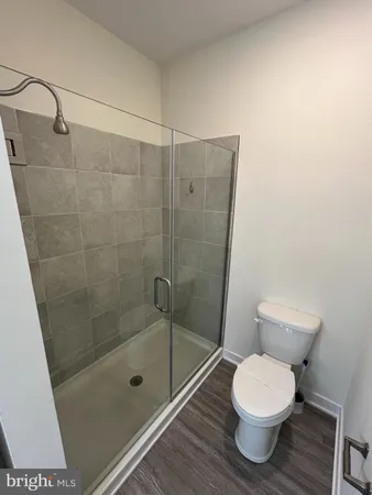 a bathroom with a shower a toilet and a sink