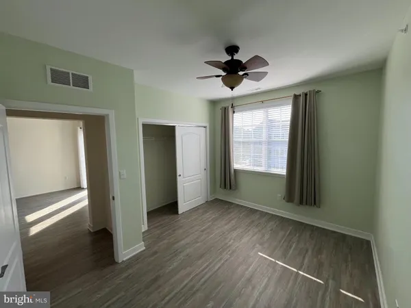 a view of a livingroom with a ceiling fan and window