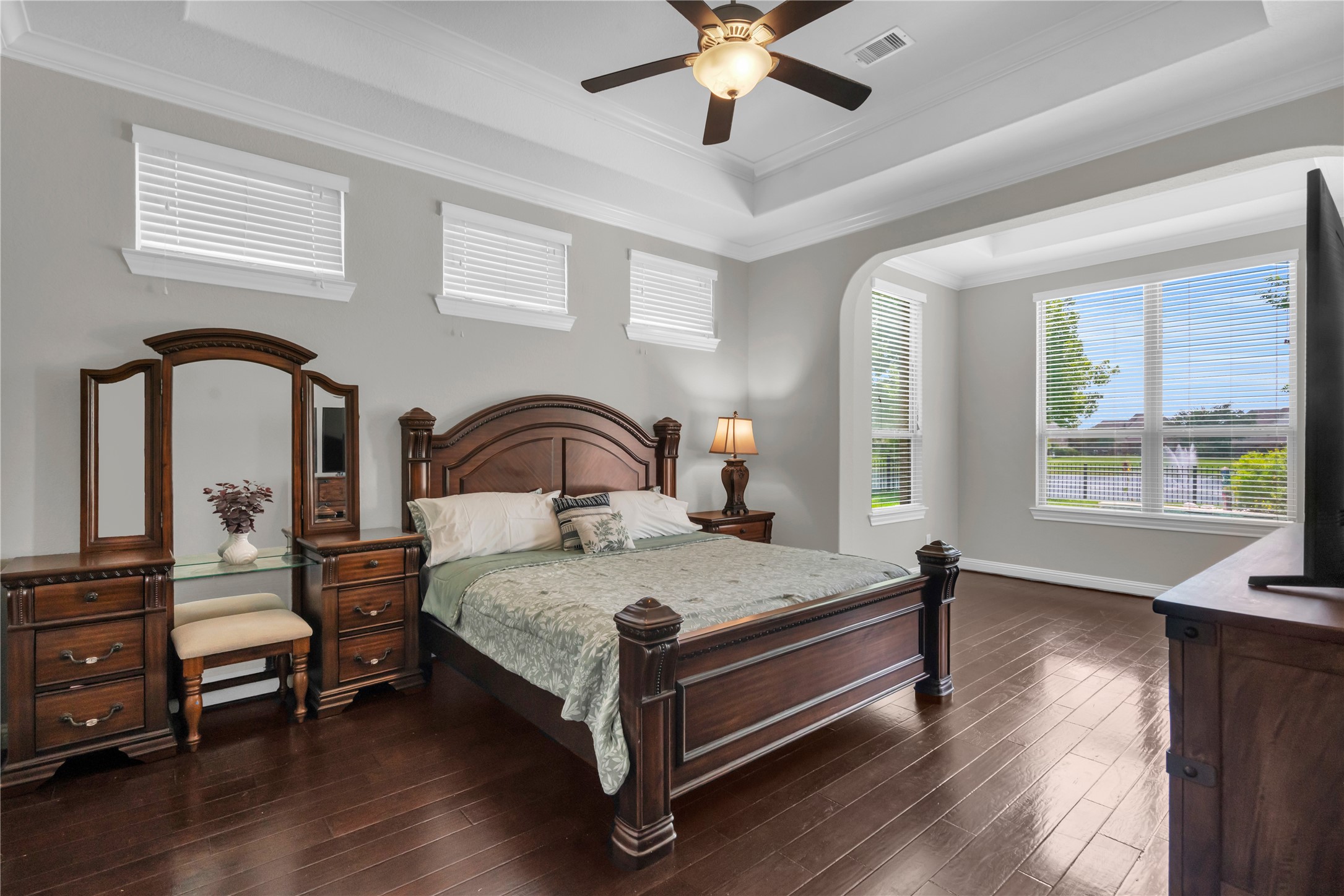 9842 Kirkstone Terrace Drive Spring, TX 77379 - Photo 15 of 34 This spacious bedroom features elegant hardwood floors, a tray ceiling with a ceiling fan, and ample natural light from high windows with sitting room overlooking the pool and lake!