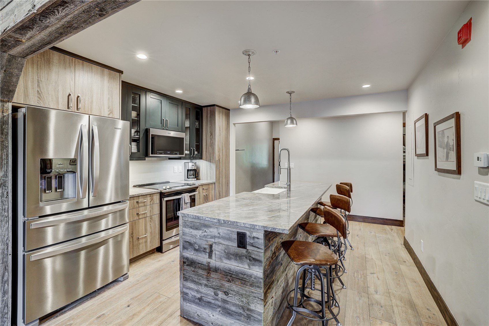 620 4 O Clock Road, Unit 336 Breckenridge, CO 80424 - Photo 5 of 29 Kitchen featuring decorative light fixtures, stainless steel appliances, light stone countertops, light wood-type flooring, and sink