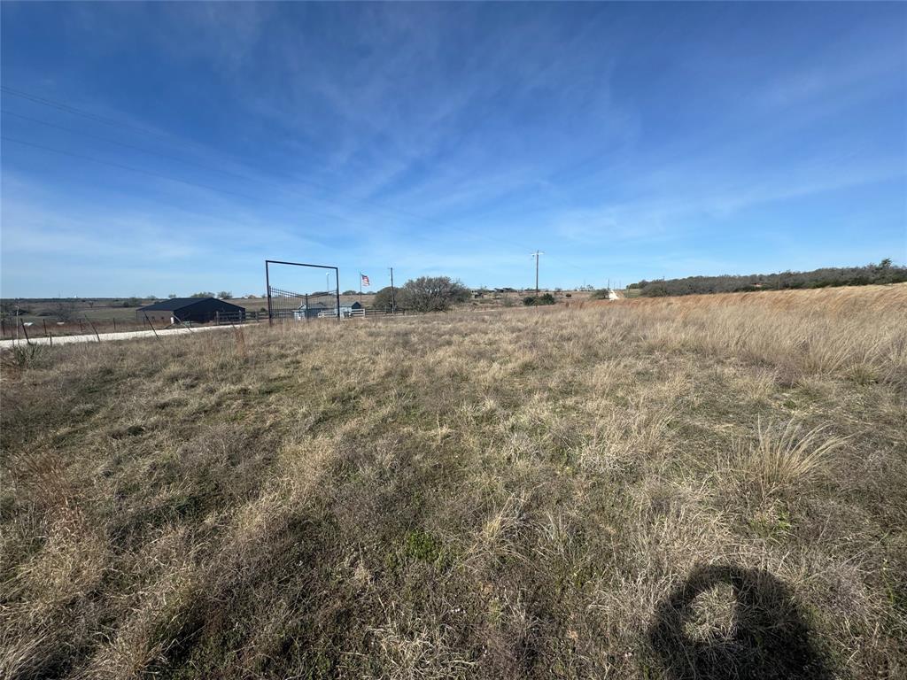 a view of a field and a building