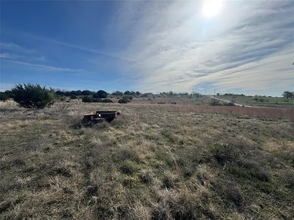 a view of a dry field with lots of bushes