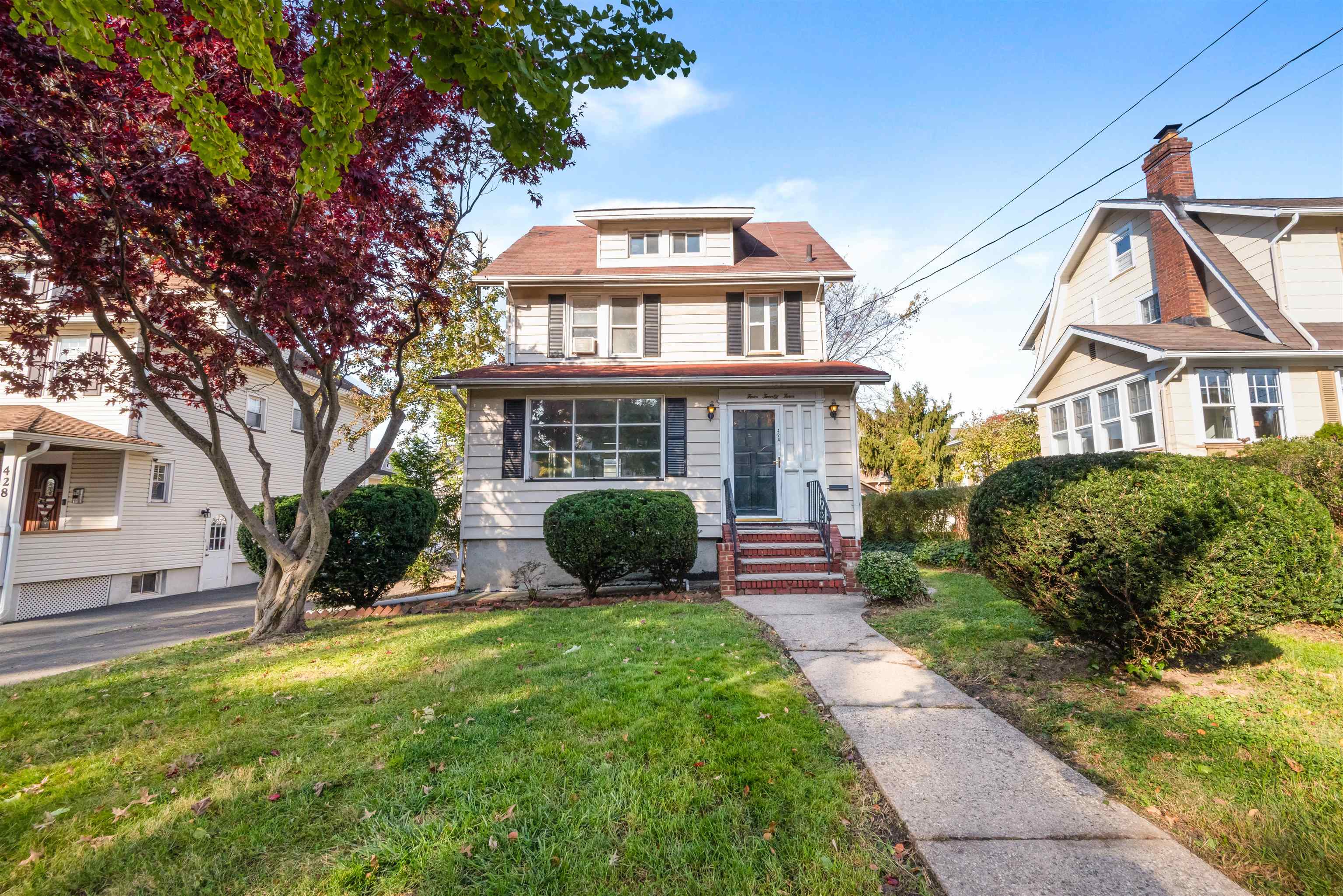 424 Lincoln Avenue Rutherford, NJ 07070 - Photo 1 of 30 a view of a brick house with a yard