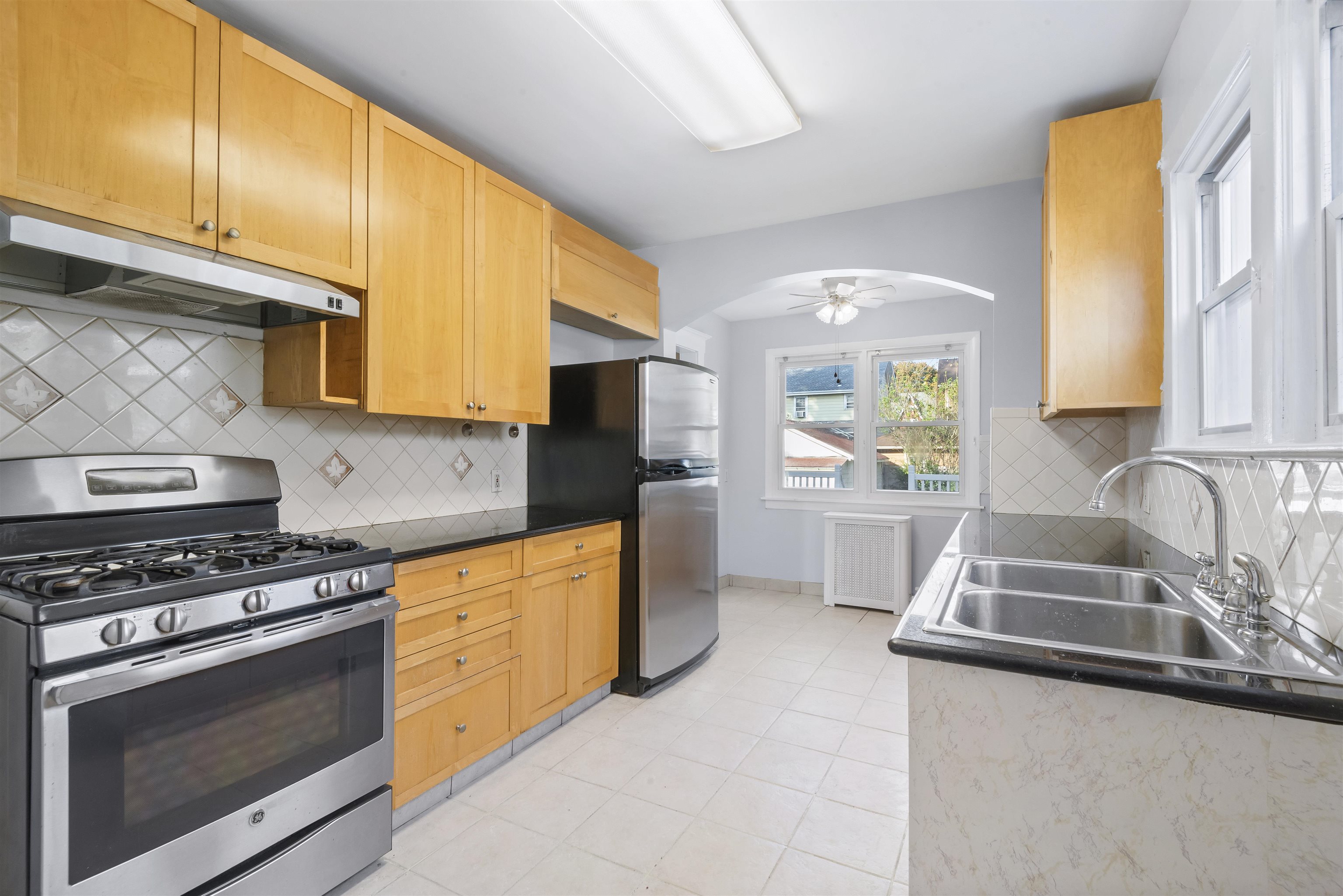 424 Lincoln Avenue Rutherford, NJ 07070 - Photo 11 of 30 a kitchen with granite countertop a sink a stove and refrigerator