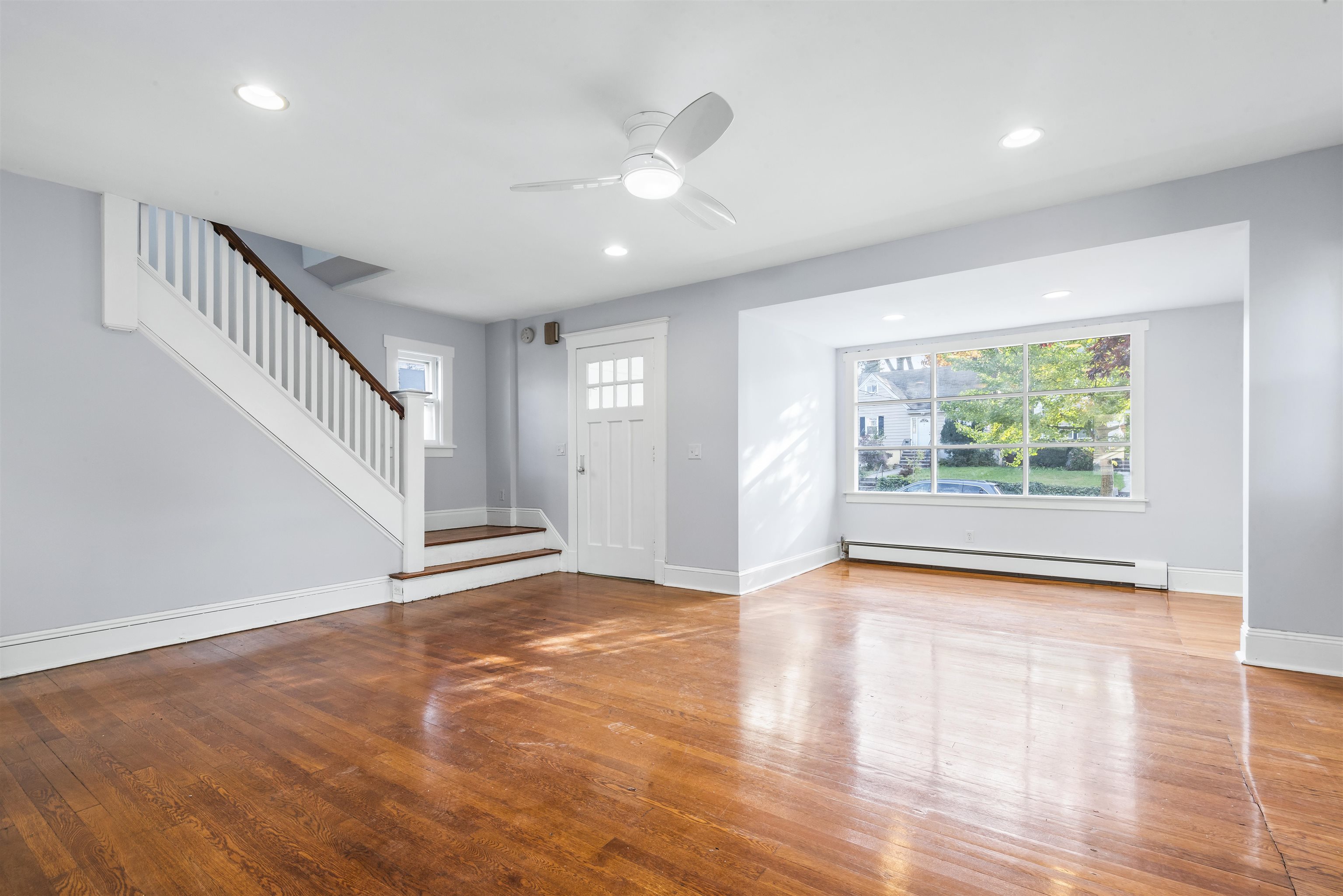 424 Lincoln Avenue Rutherford, NJ 07070 - Photo 6 of 30 a view of an empty room with wooden floor and a window
