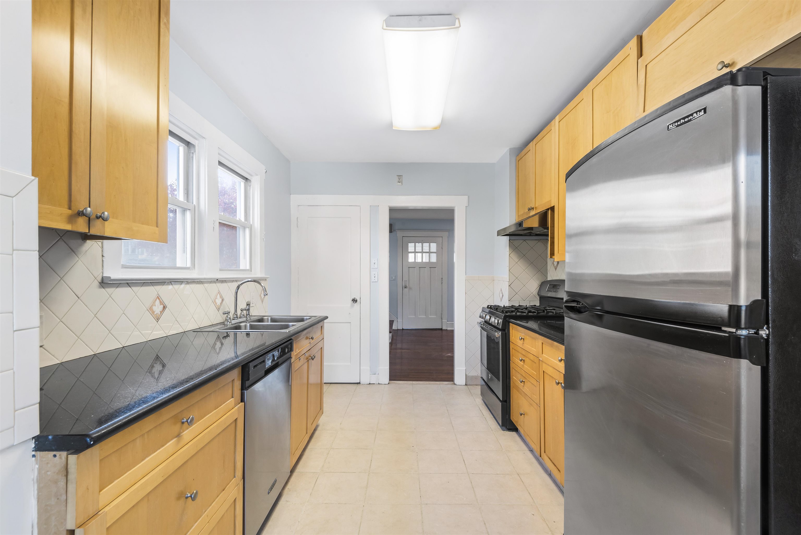 424 Lincoln Avenue Rutherford, NJ 07070 - Photo 10 of 30 a kitchen with a sink and a refrigerator
