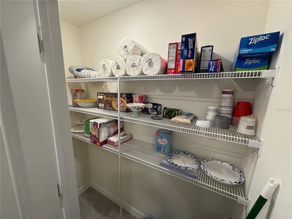 a kitchen with lots of clutter and cabinets