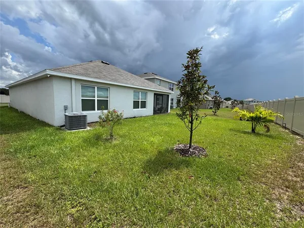 a view of a house with a yard and garage