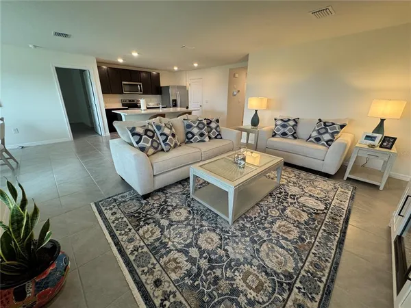 a living room with furniture and a rug