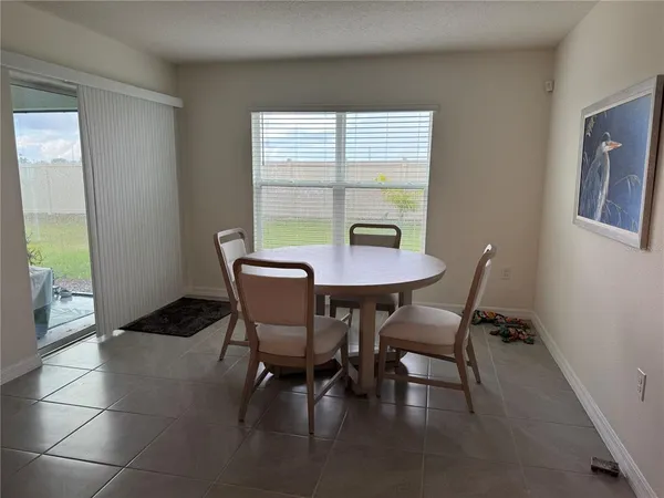 a view of a dining room with furniture and a window