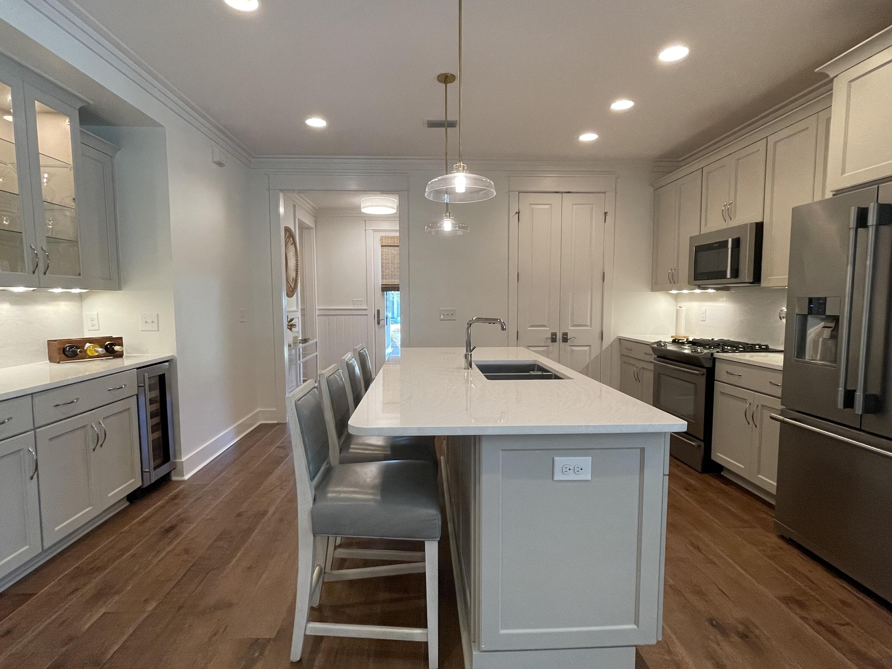 27 Somersault Lane Inlet Beach, FL 32461 - Photo 41 of 42 a kitchen with kitchen island white cabinets and stainless steel appliances