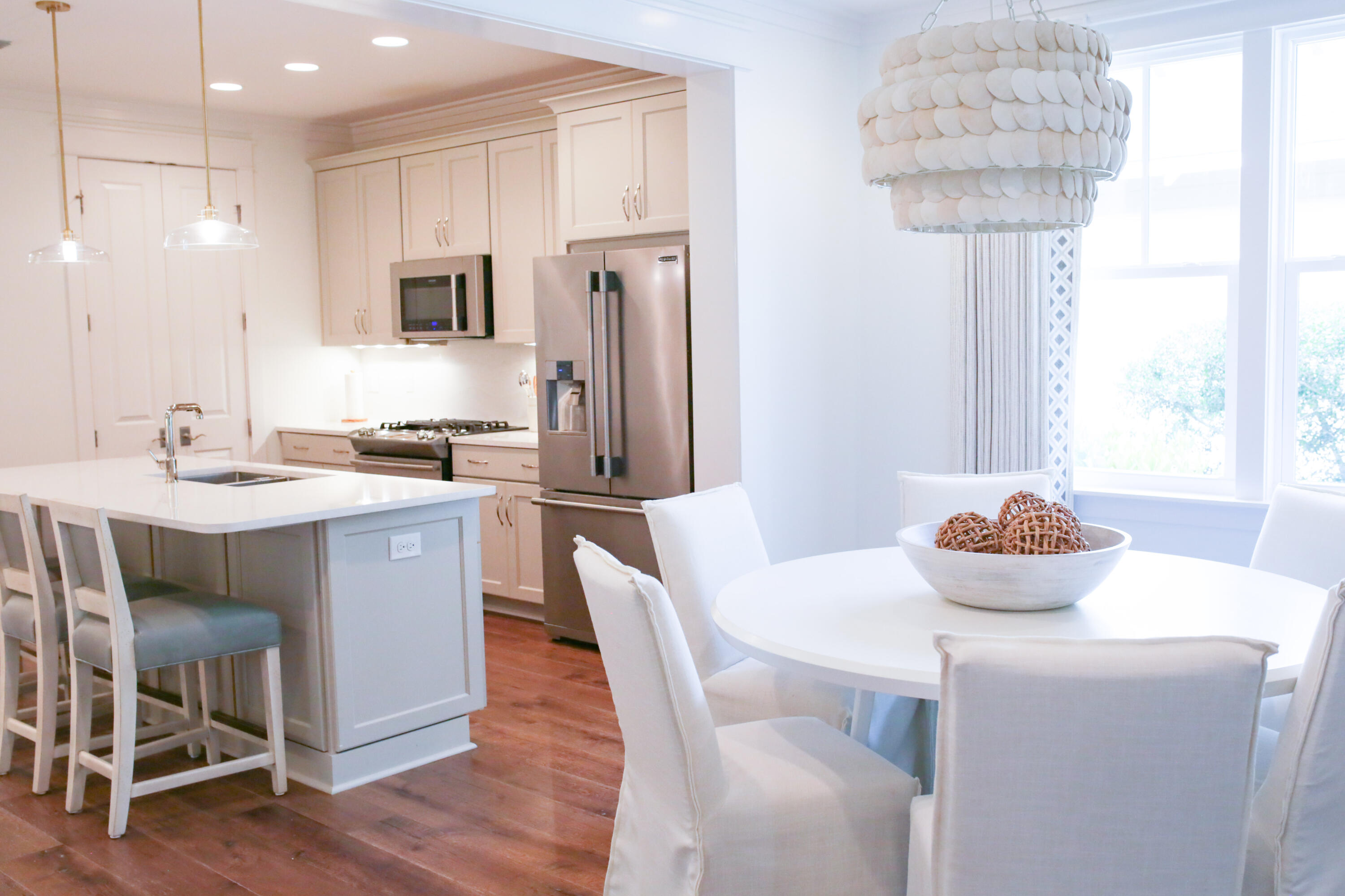 27 Somersault Lane Inlet Beach, FL 32461 - Photo 7 of 42 a kitchen with stainless steel appliances a dining table chairs and a refrigerator