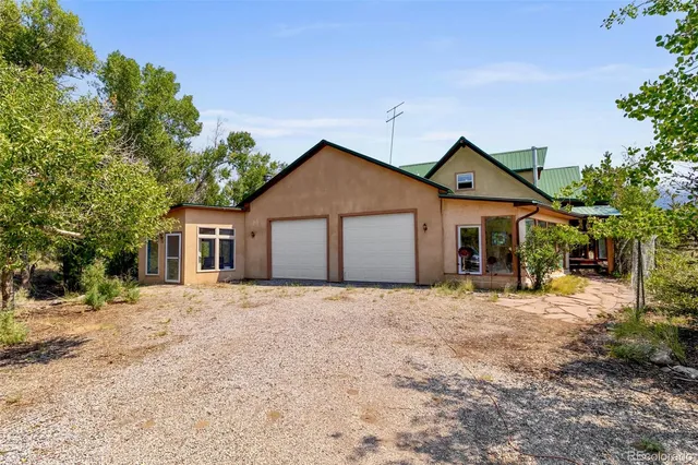 a view of a chairs and table in the patio