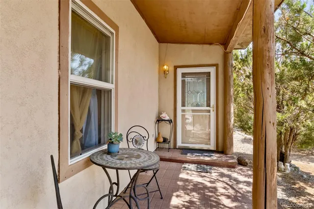 a bedroom with furniture and large windows
