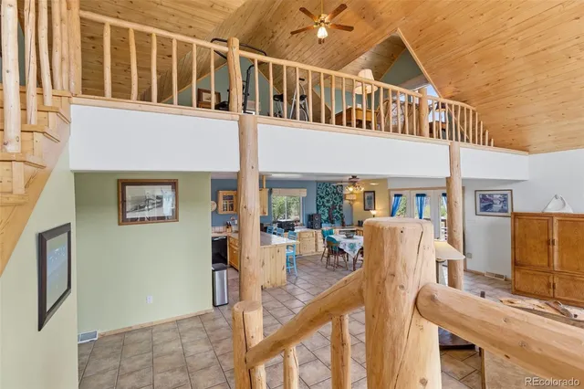 a view of a livingroom with furniture and a ceiling fan