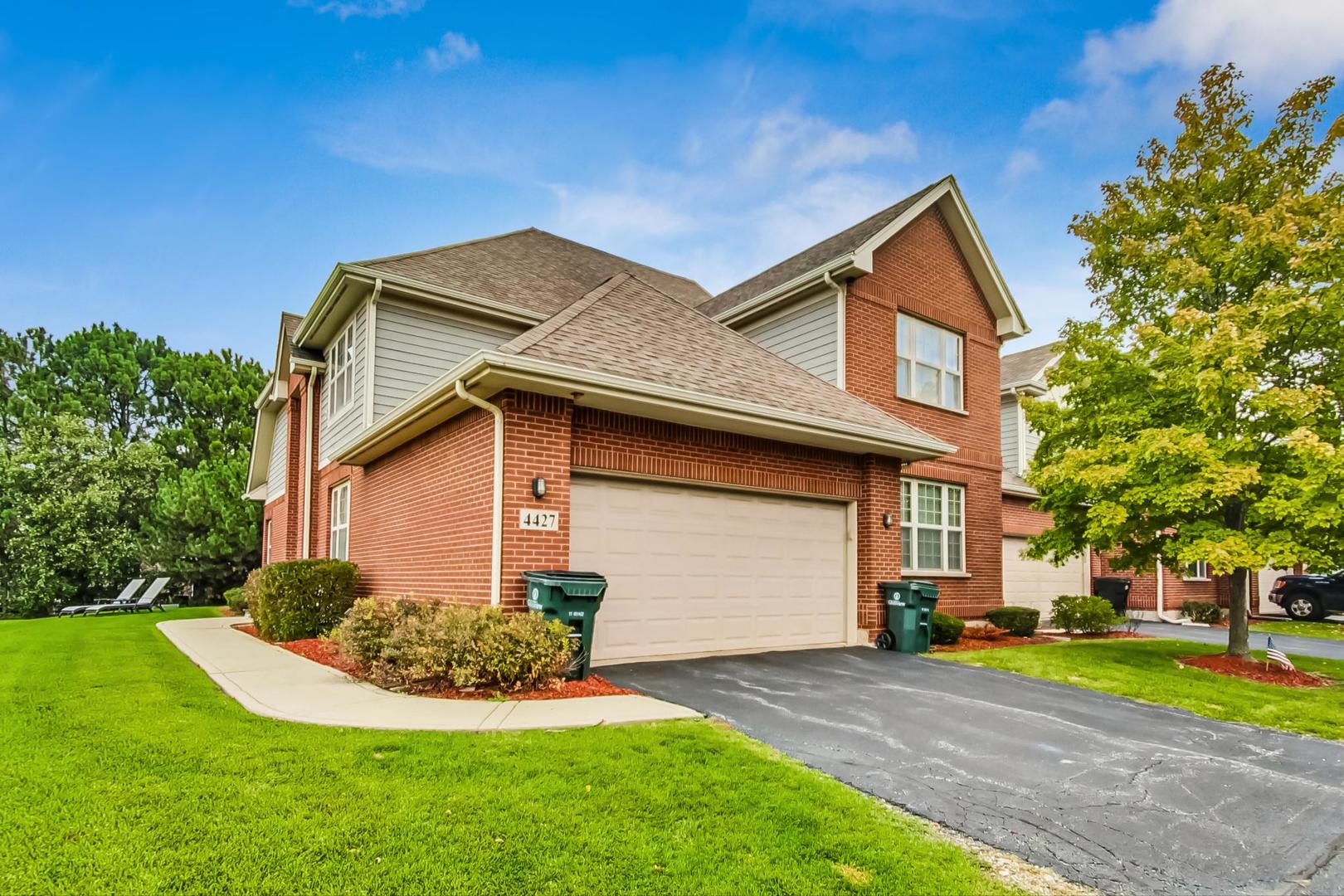 4427 Lainie Circle Glenview, IL 60026 - Photo 2 of 20 a front view of a house with a yard and garage