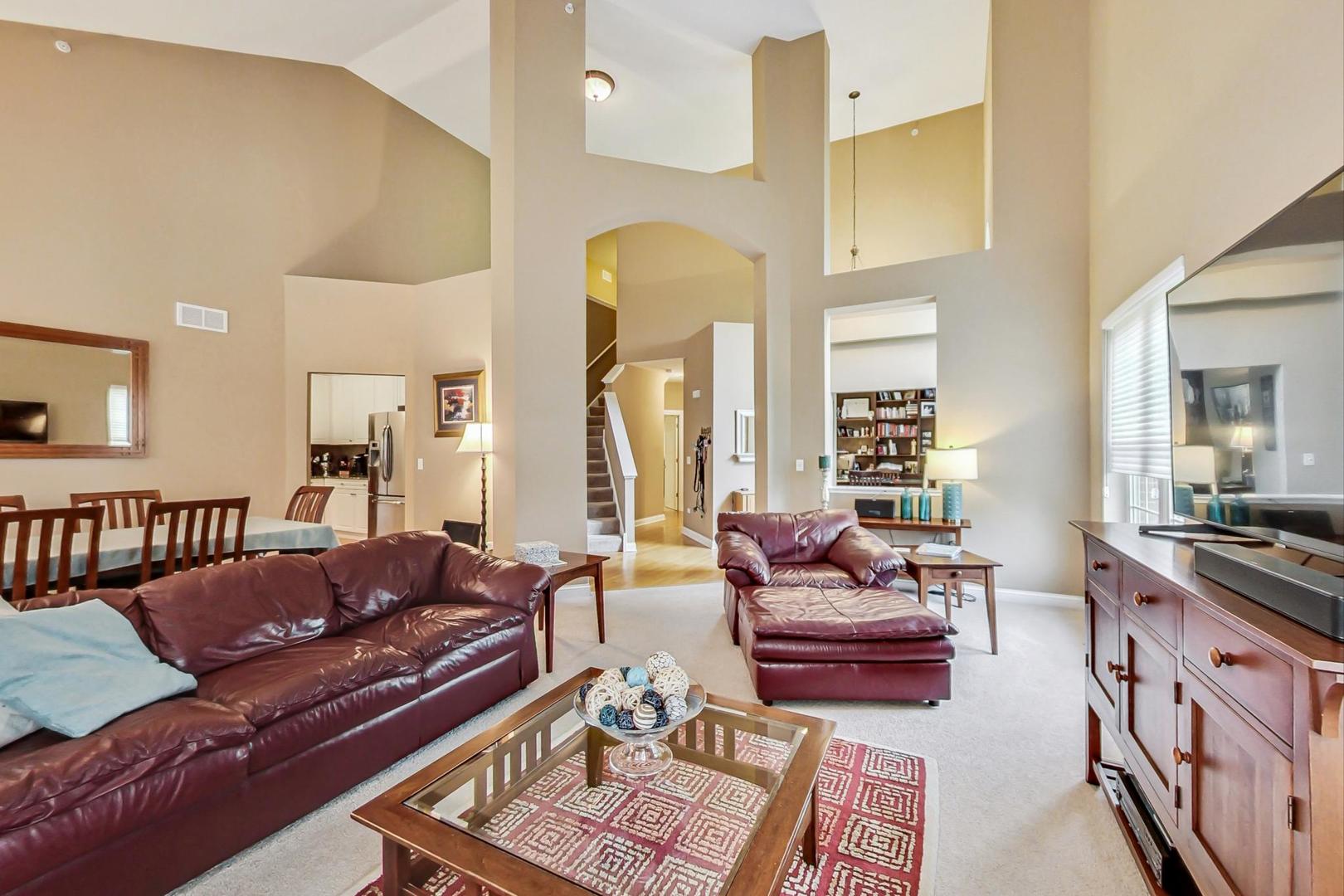 4427 Lainie Circle Glenview, IL 60026 - Photo 8 of 20 a living room with furniture fireplace and a table