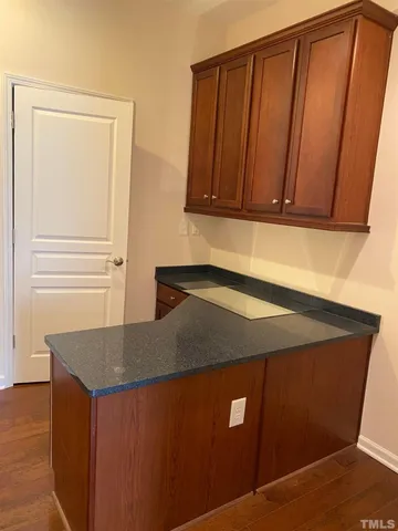 a view of a refrigerator in kitchen and wooden floor