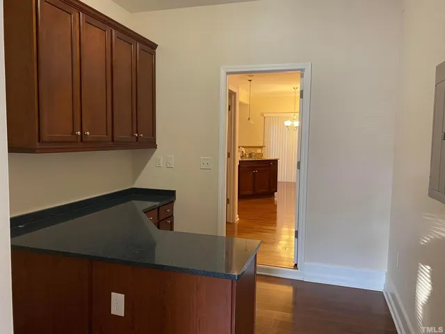 a kitchen with a refrigerator and cabinets