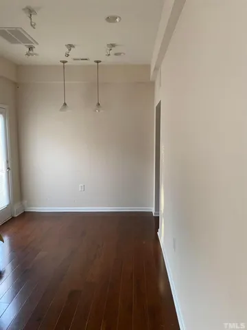 a view of a room with wooden floor