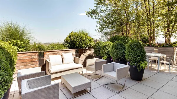 a view of a patio with couches and potted plants