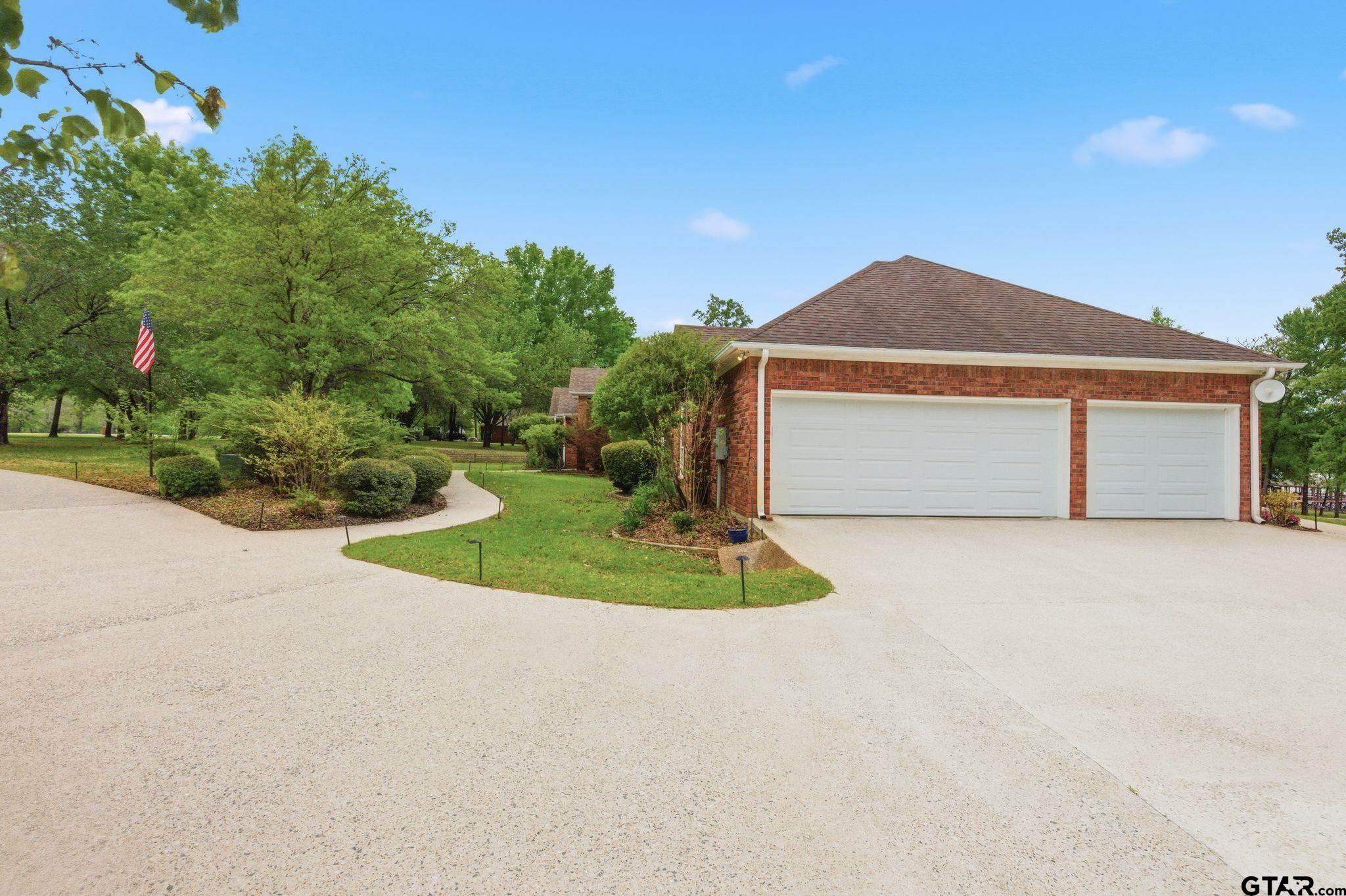 511 Rcr 3346 Emory, TX 75440 - Photo 47 of 48 a front view of a house with a yard and garage